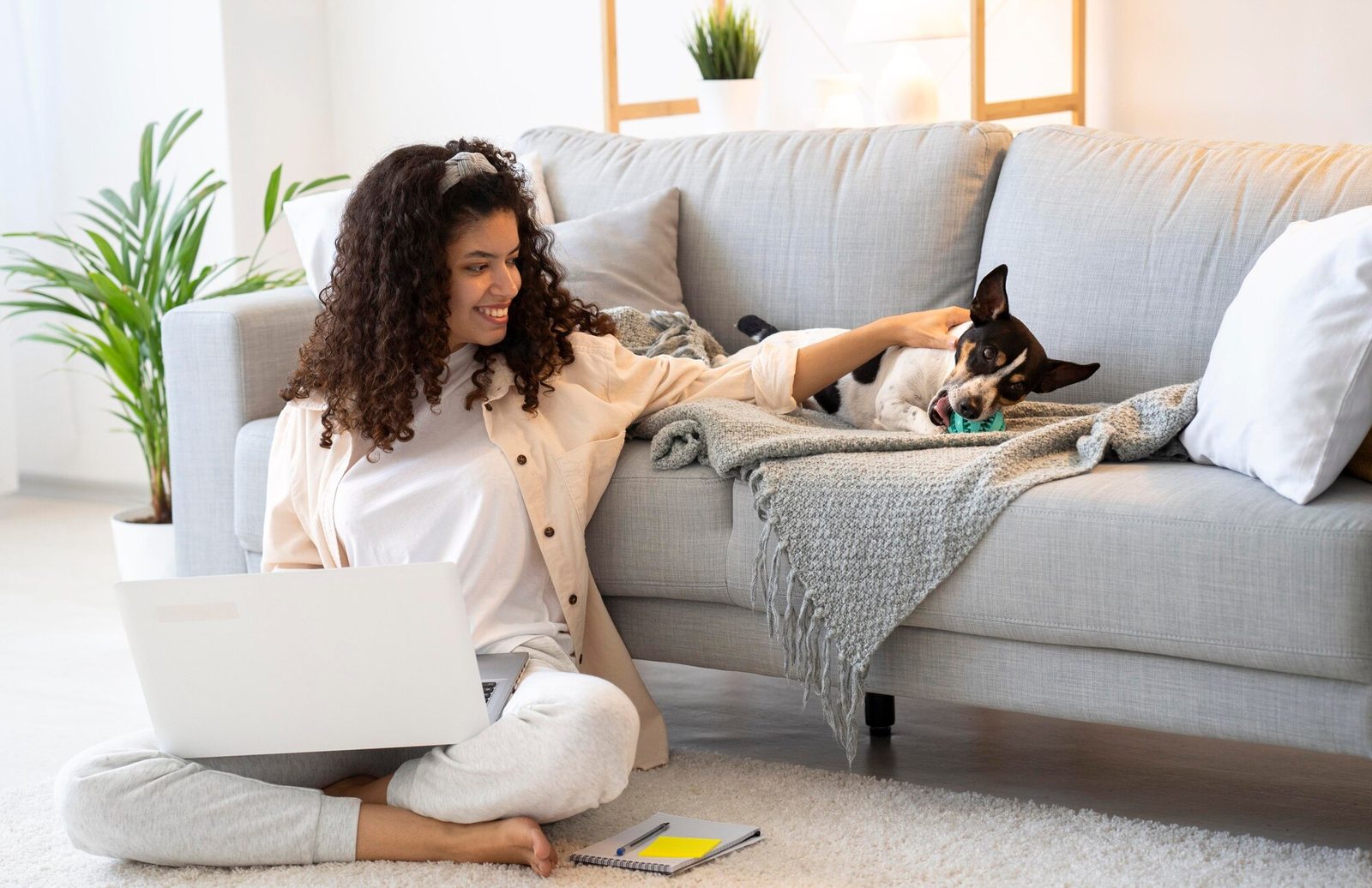 Pet owner with dog at home applying for an ESA letter online